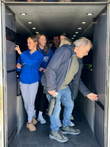 Students and teachers touring inside race transporter